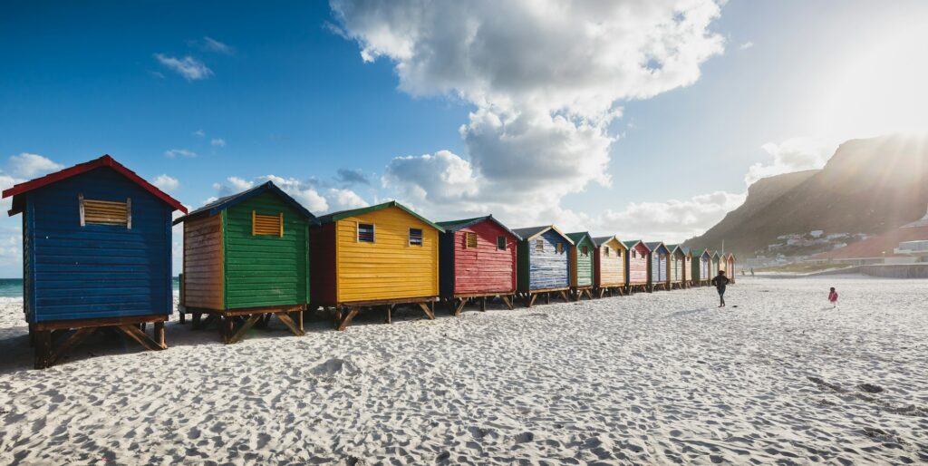 Colorful beach cabins at sunset in Muizenberg, Cape Town, South Africa