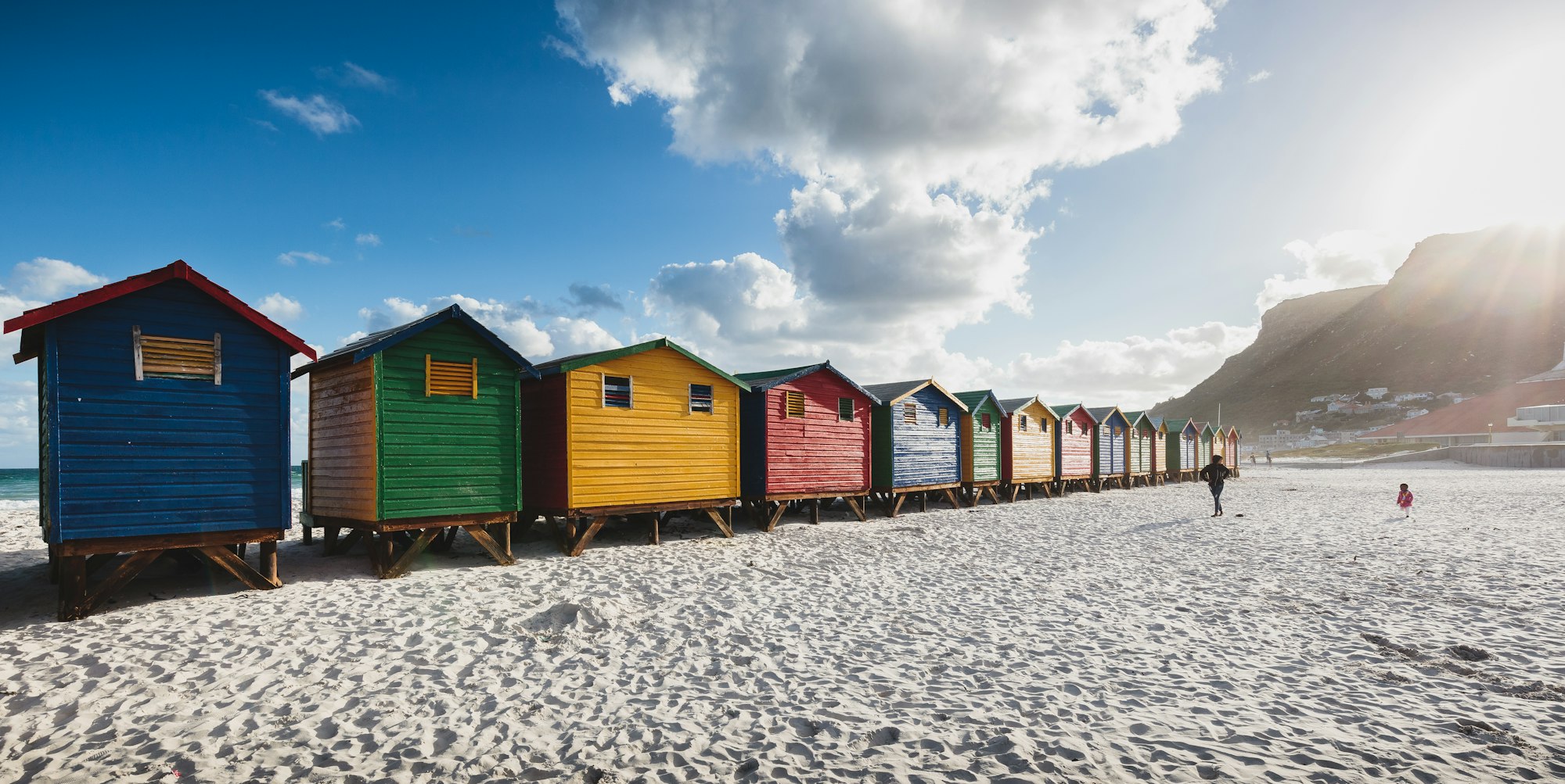 Colorful beach cabins at sunset in Muizenberg, Cape Town, South Africa